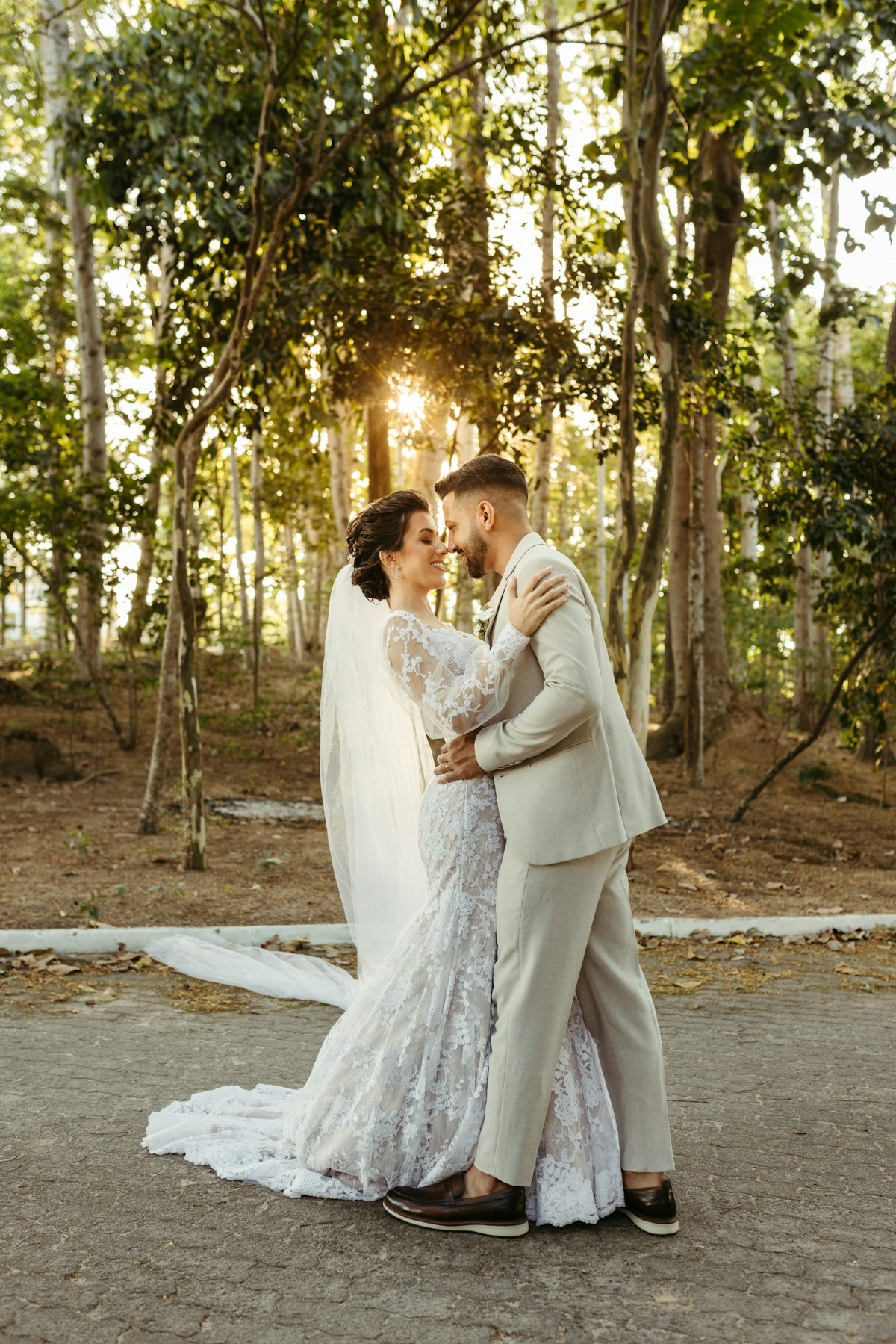 A couple embracing in the golden light of their wedding day